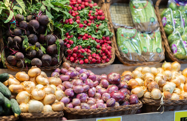 Long row of display cases filled with fresh vegetables in store. Self-service store offers wide range of imported vegetables and fruits from around world. Range of agricultural products from local