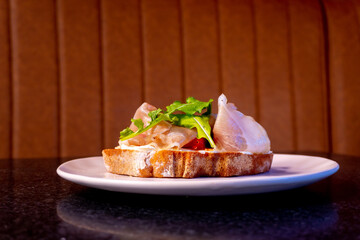 Delicious bruschetta with prosciutto and fresh ingredients beautifully presented on a plate.