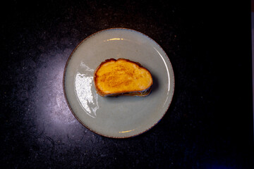 A simple grilled cheese sandwich on a teal plate, a comforting culinary treat.