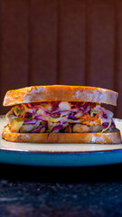 A mouthwatering sandwich with colorful filling, ready to be enjoyed for a delicious meal.