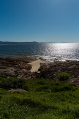 Ocean view with rocky coastline on a sunny day.