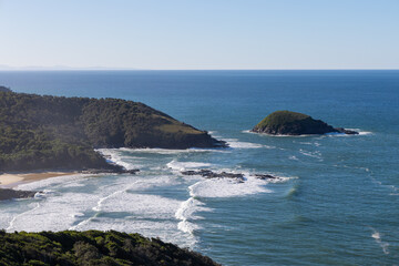 Aerial view of coastal landscape with sunny sky.
