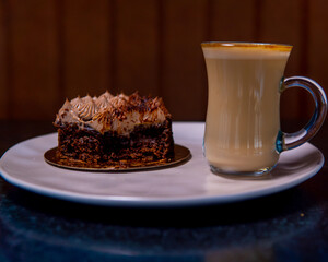 Delicious slice of chocolate cake with whipped cream and coffee beans.