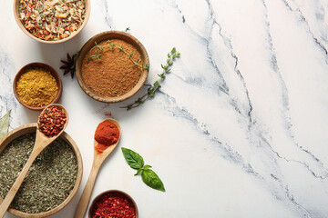 Composition with different fresh spices on light marble background