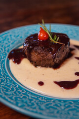 A beautifully plated steak is the star of this fine dining shot.