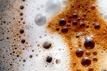 Coffee on frothed milk as background