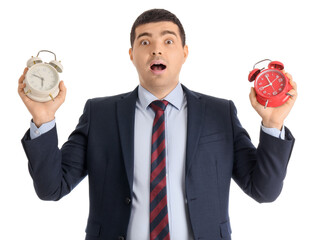 Shocked businessman with alarm clocks on white background. Time management concept