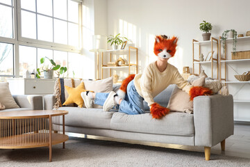 Quadrober girl in cat disguise playing at home