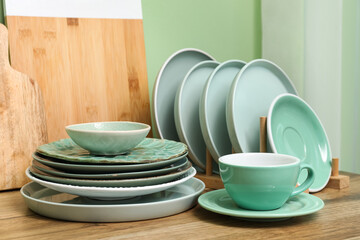 Holder with clean plates and cup on counter in kitchen