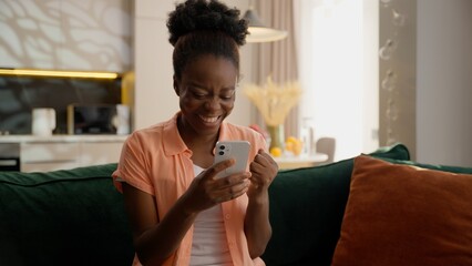Excited winner African American business woman ethnic female girl businesswoman holding mobile...