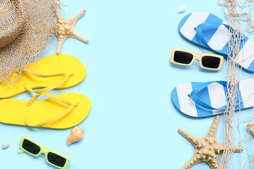 Frame made of seashells, starfishes and beach accessories on blue background