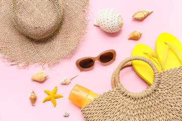Composition with seashells, starfish and beach accessories on pink background