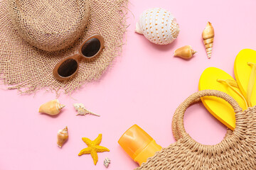 Frame made of seashells, starfish and beach accessories on pink background
