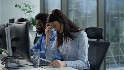 Tired exhausted Caucasian business woman callcenter worker headset touch head suffer headache pain...