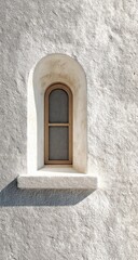 Ancient arched window, weathered stone wall, sunlit exterior. Historical use