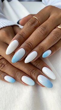 Beautiful almond shaped nails with white and blue ombre gradient