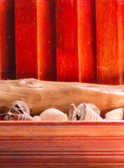 Wooden Wall Decor with Seashells, Coral, and Driftwood Natural Accents. A rustic wooden frame...