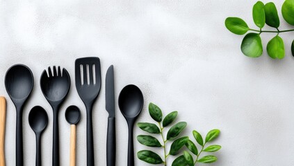 Kitchen tools arranged on a light gray surface with leaves.  Modern cooking.  Possible use  catalog, website
