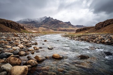 Iceland mountain river flowing through valley, cloudy sky.  Possible use Stock photo