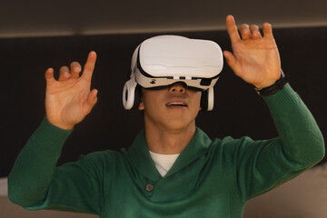 White virtual reality headset projecting interface on dark wall with glowing controls, copy space