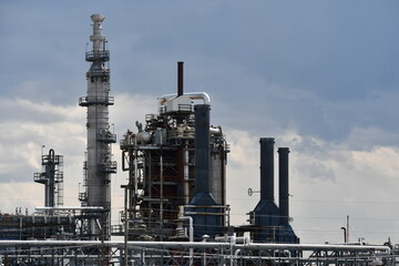 Oil refinery. Lots of steam stacks and towers.