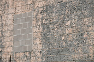 Old brick wall. Filled in window with newer brick.