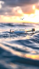 A message in a bottle with happy birthday floating on the ocean at sunset with a bird