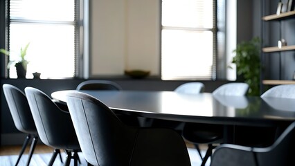 Interior of a conference room featuring a dark table and gray upholstered chairs