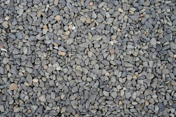 Gray gravel stones textured background consisting of small pebbles in natural harmonious colors