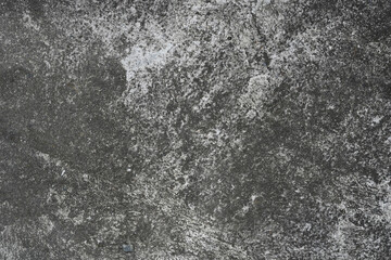 Detailed view of a gray concrete surface showcasing cracks and weathered textures, providing a raw, industrial feel. Ideal for backgrounds, construction themes, or conceptual