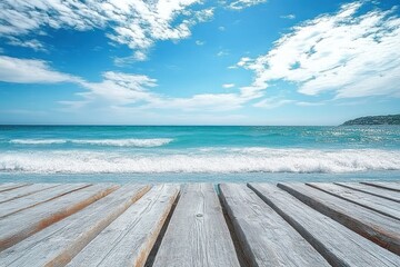 Calm ocean scene with gentle waves under partly cloudy blue sky viewed from weathered wooden pier during daytime