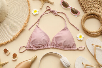 Composition with swimsuit, bottle of cosmetic product and beach accessories on beige background,...
