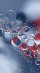 A close up of floating water droplets with red and blue reflections and sparkling particles around them