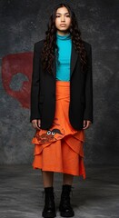 Model in orange skirt blue turtleneck and black blazer
