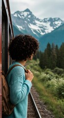 Traveler with backpack on train looking at mountains