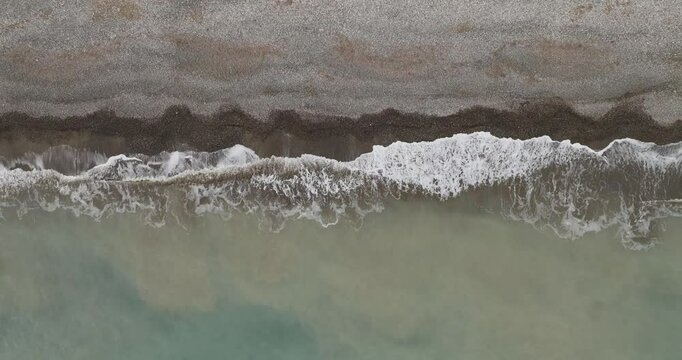 Aerial view of waves crashing on tranquil shore, Cyprus.