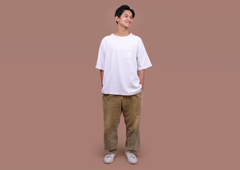 Full Body of Young Asian Man Wears White T-shirt and Looking Aside on Beige Background Studio