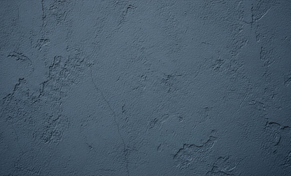 Dark blue textured wall surface with uneven patches and rough appearance.