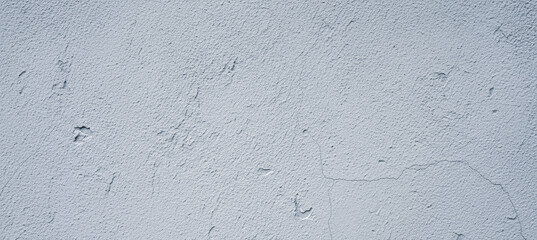 Light gray textured surface with subtle imperfections and variations in tone.