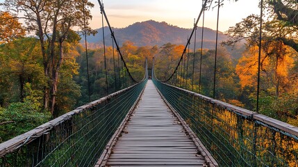 Obraz premium A towering mountain, with a wooden bridge crossing through misty clouds, and clear, bright skies framing the majestic scene.