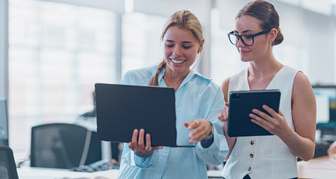 Women Engaging in Collaborative Efforts on Digital Devices within a Contemporary Office Environment