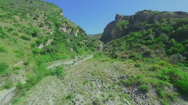 From the valley the path leads between two mountains