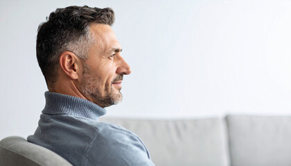 Obraz premium Side view head shot of a man meditating in a chair against a white background.