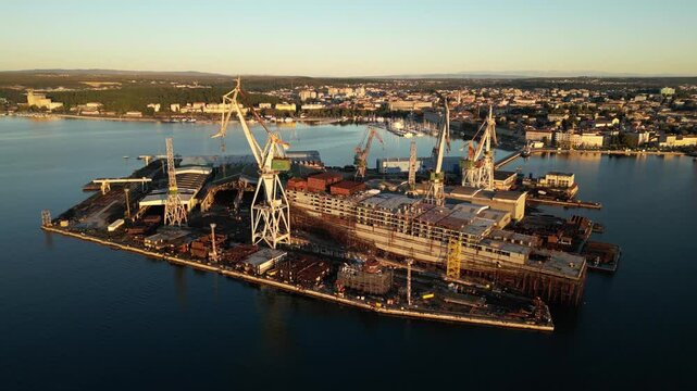 Aerial view of shipyard with cranes and vessels, Croatia.