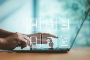Typing on laptop with floating digital document icons, representing paperless workflow, cloud storage, and secure online document management in modern businesses.