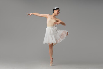 Graceful Ballerina: A poised ballerina on pointe in a classic pose wearing a tutu and headpiece