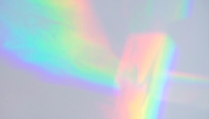 Soft rainbow light leak creates a colorful prism effect across a plain wall background, ideal for abstract designs and backgrounds.