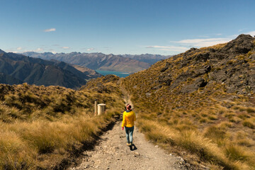 hiker enjoying the  Lake scenery of an alpine lake hiking up  the Isthmus track trail