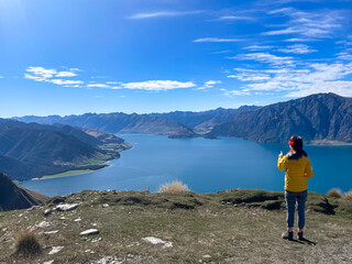 hiker enjoying the  Lake scenery of an alpine lake hiking up  the Isthmus track trail