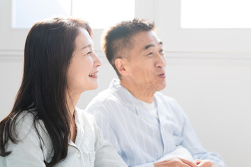 起きてベッドの上で会話をする夫婦